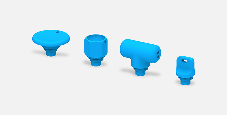 四个附在适用于 Surface 触控笔的 3D 打印握笔器上的尾帽。
