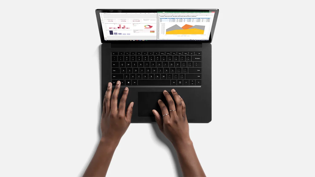 典雅黑色的 Surface Laptop 4 商用版俯视图，两只手在键盘上打字。